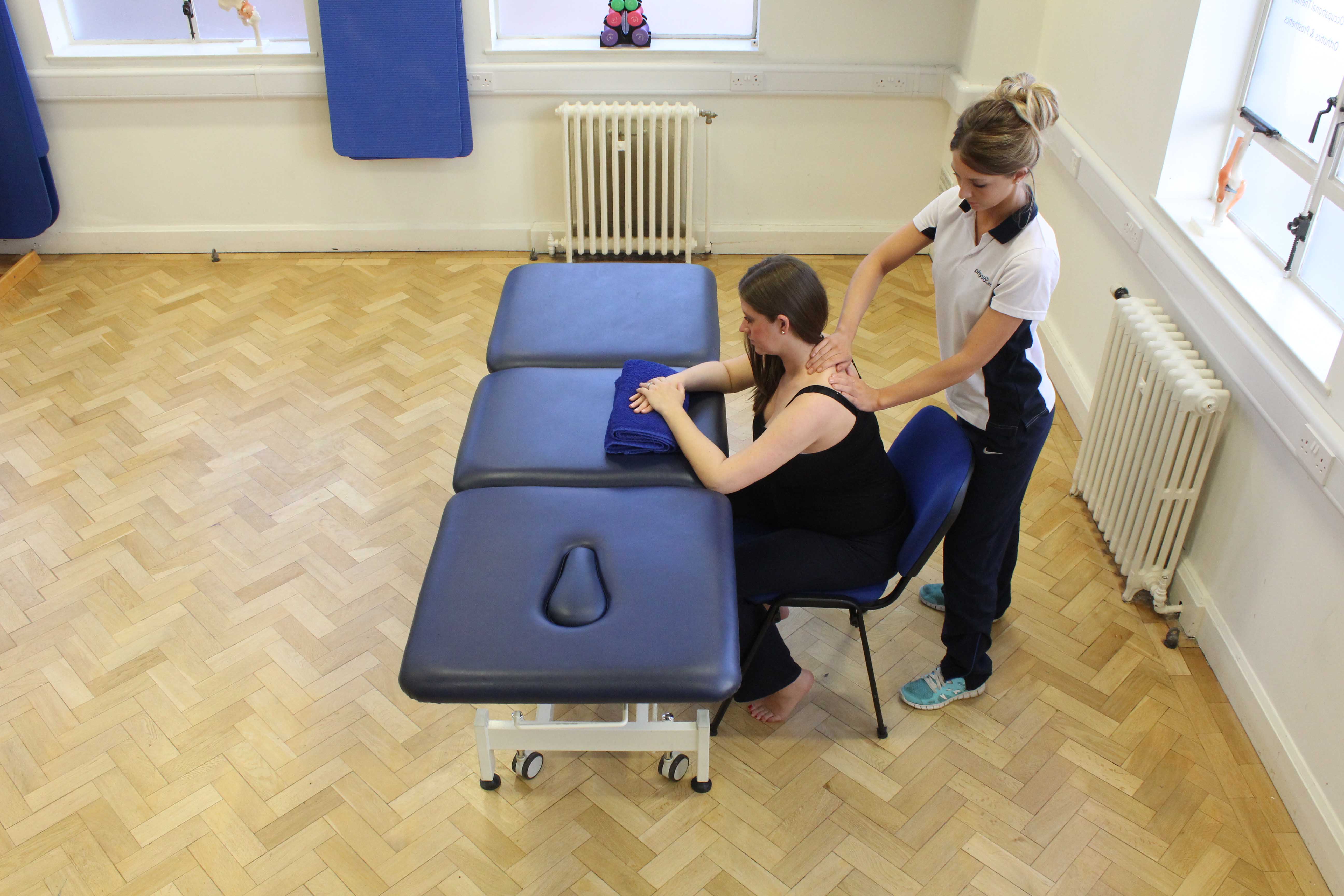 Soft tissue massage of the muscle and connective tissues in the neck by specialist MSK therapist Soft tissue massage of the muscle and connective tissues in the neck by specialist MSK therapist