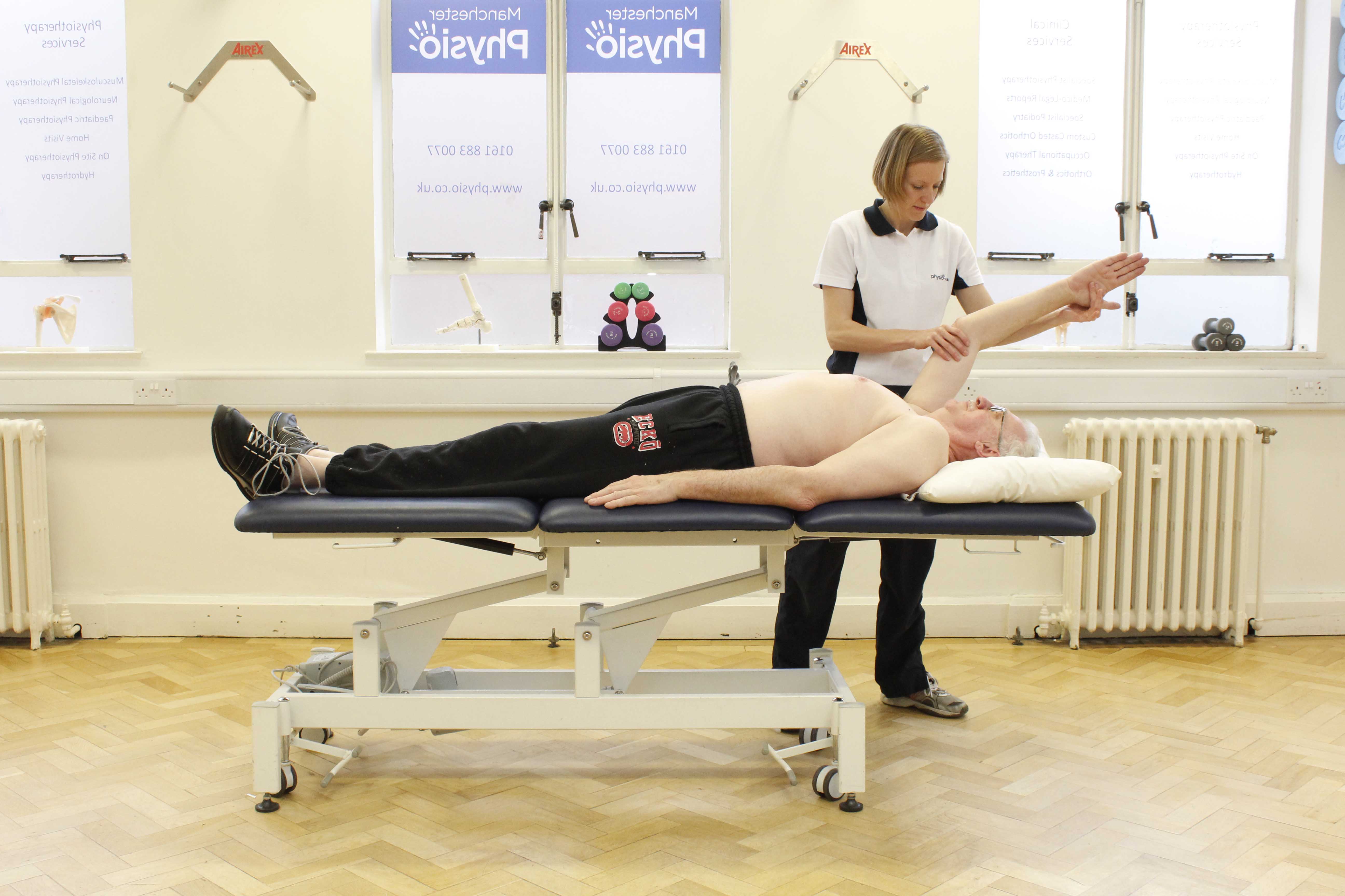 Physiotherapist facilitating a passive stretch of the arm
