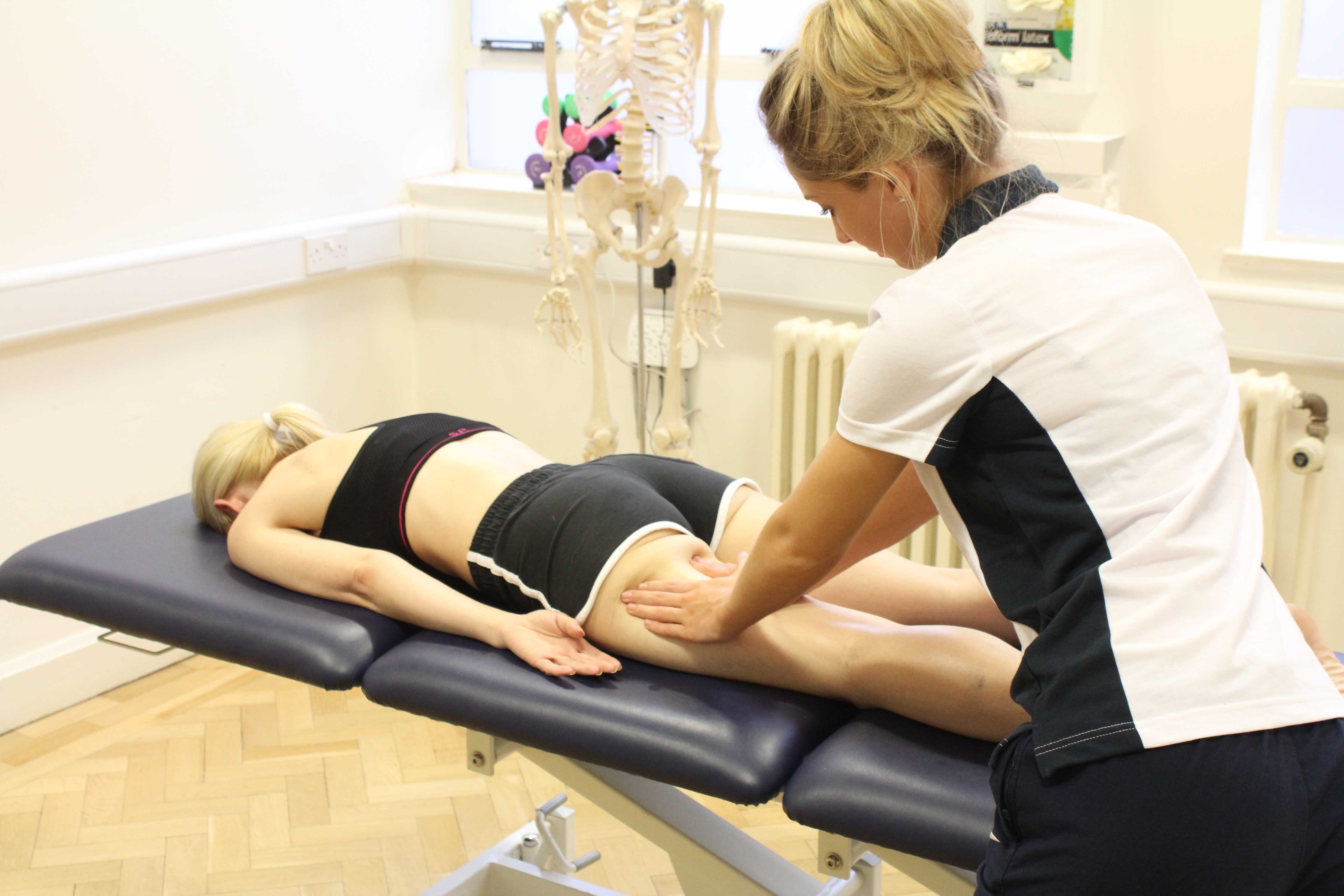 Soft tissue massage of the hamstring muscles by experienced therapist Soft tissue massage of the hamstring muscles by experienced therapist
