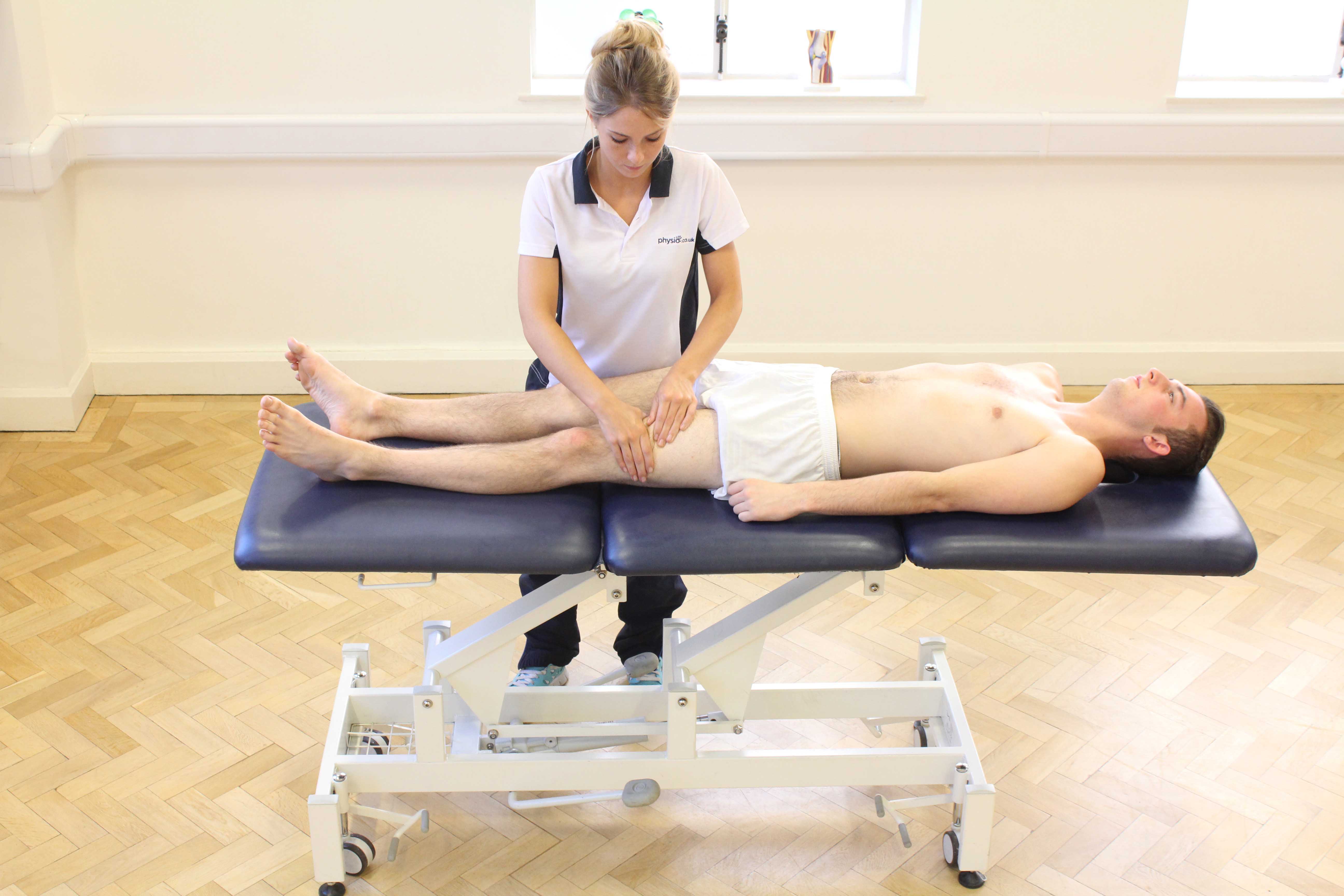 Rolling soft tissue massage of the quadriceps muscles by a specialist MSK therapist