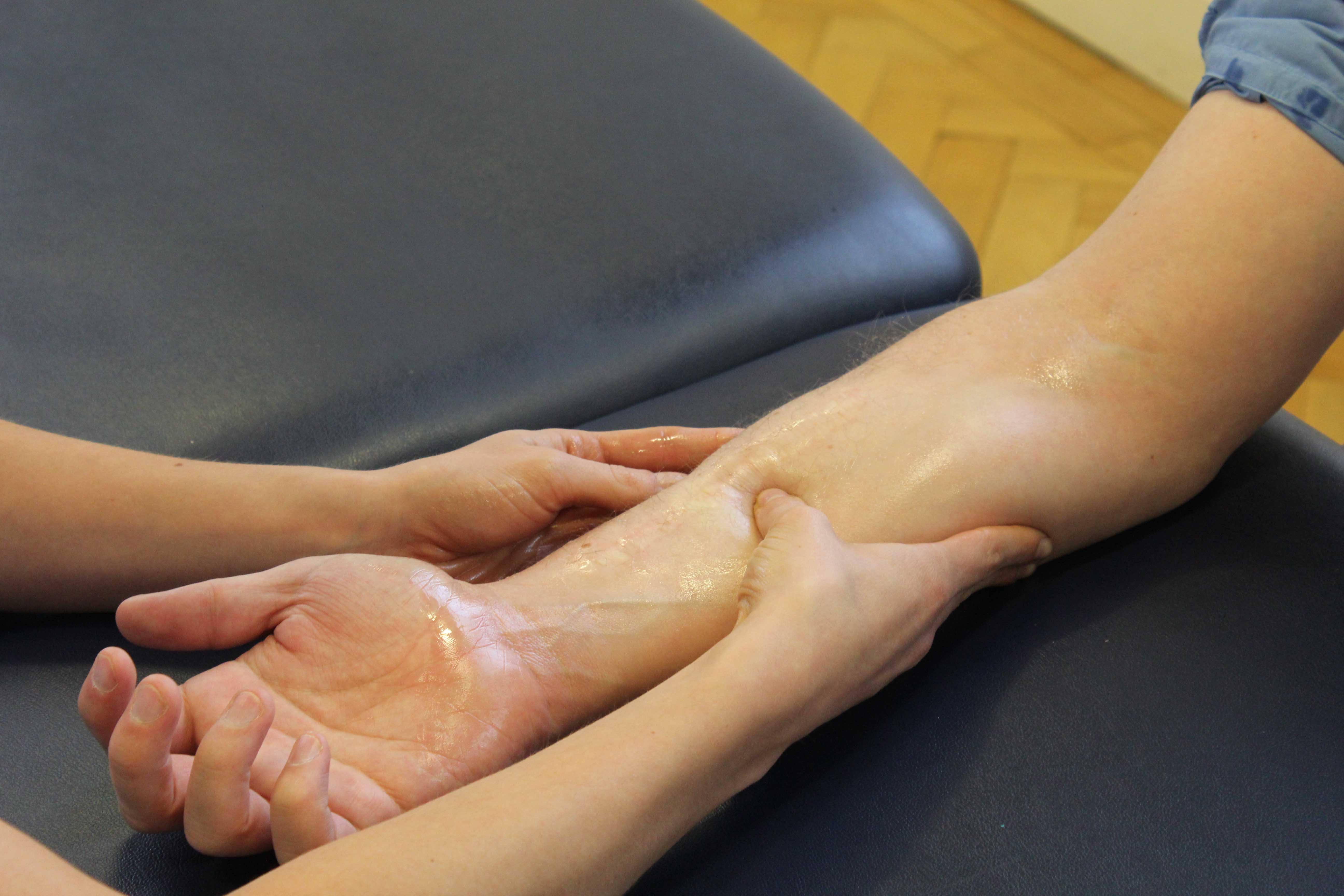 Soft tissue massage of the muscle and tendons in the forearm