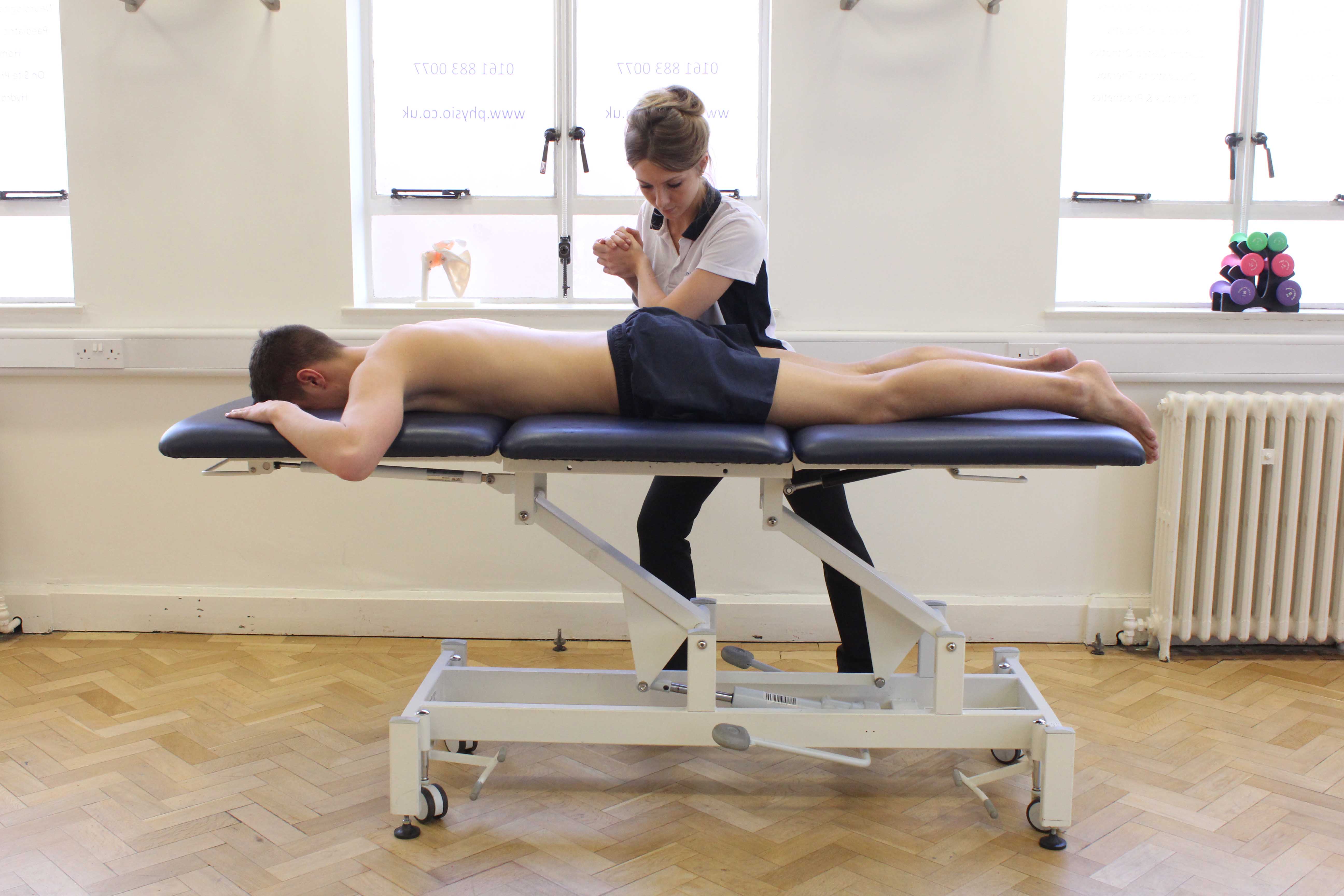 Leg strengthening and stability exercises using squats on a balance board under supervision of specialist MSK physiotherapist