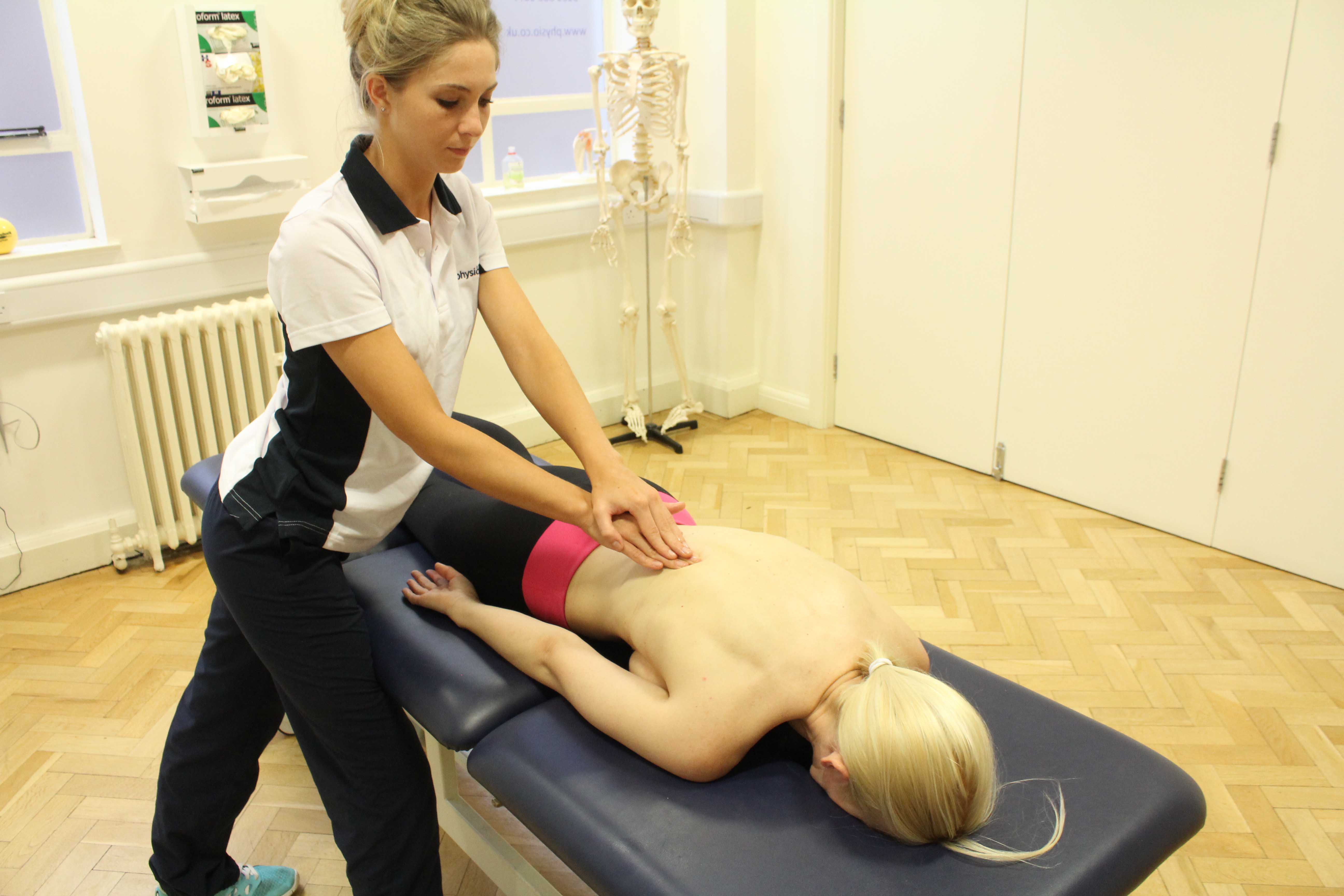 Soft tissue massage of the lower back muscles and connective tissue by specialist therapist Soft tissue massage of the lower back muscles and connective tissue by specialist therapist