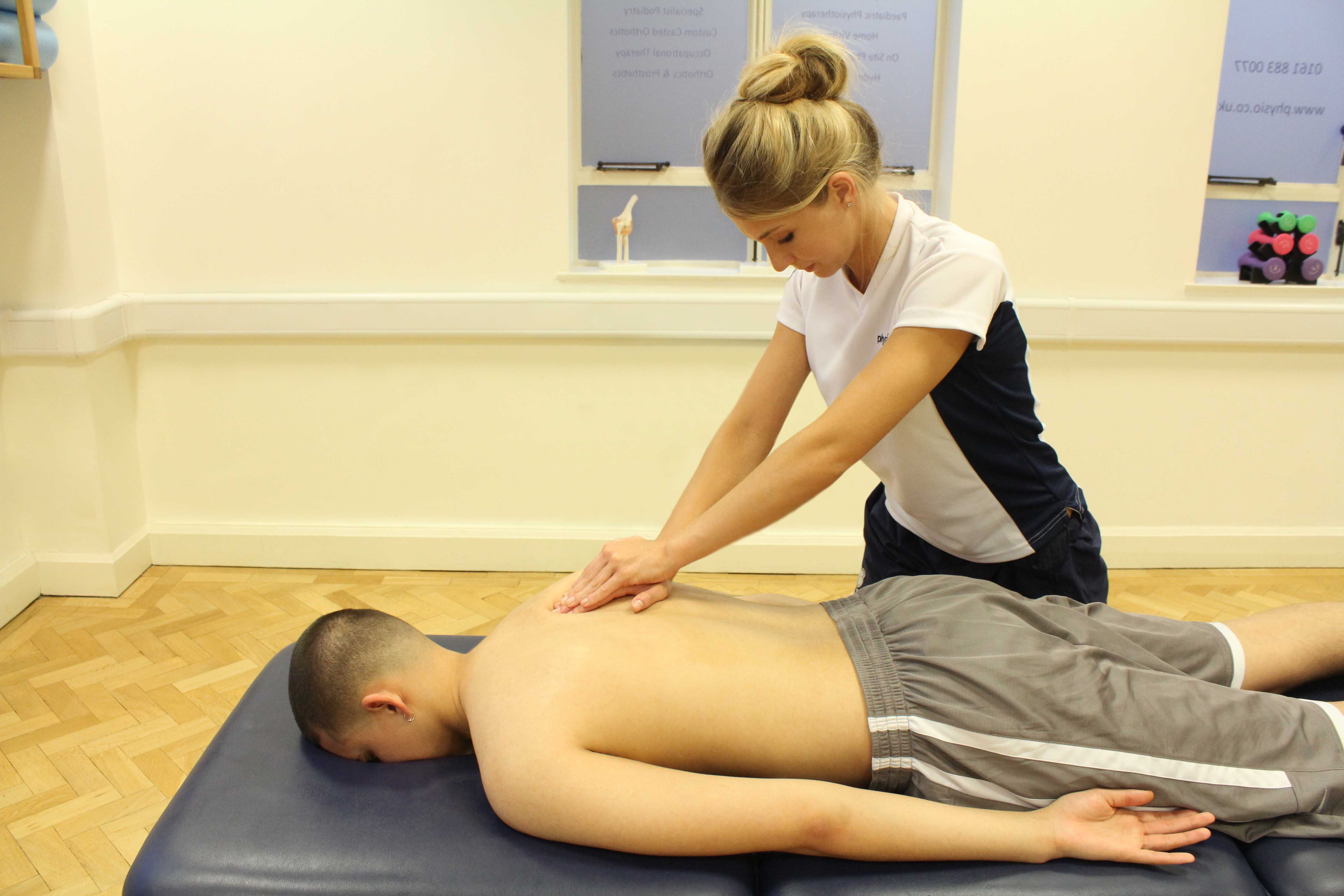 Soft tissue massage applied to the mid thoracic spine region