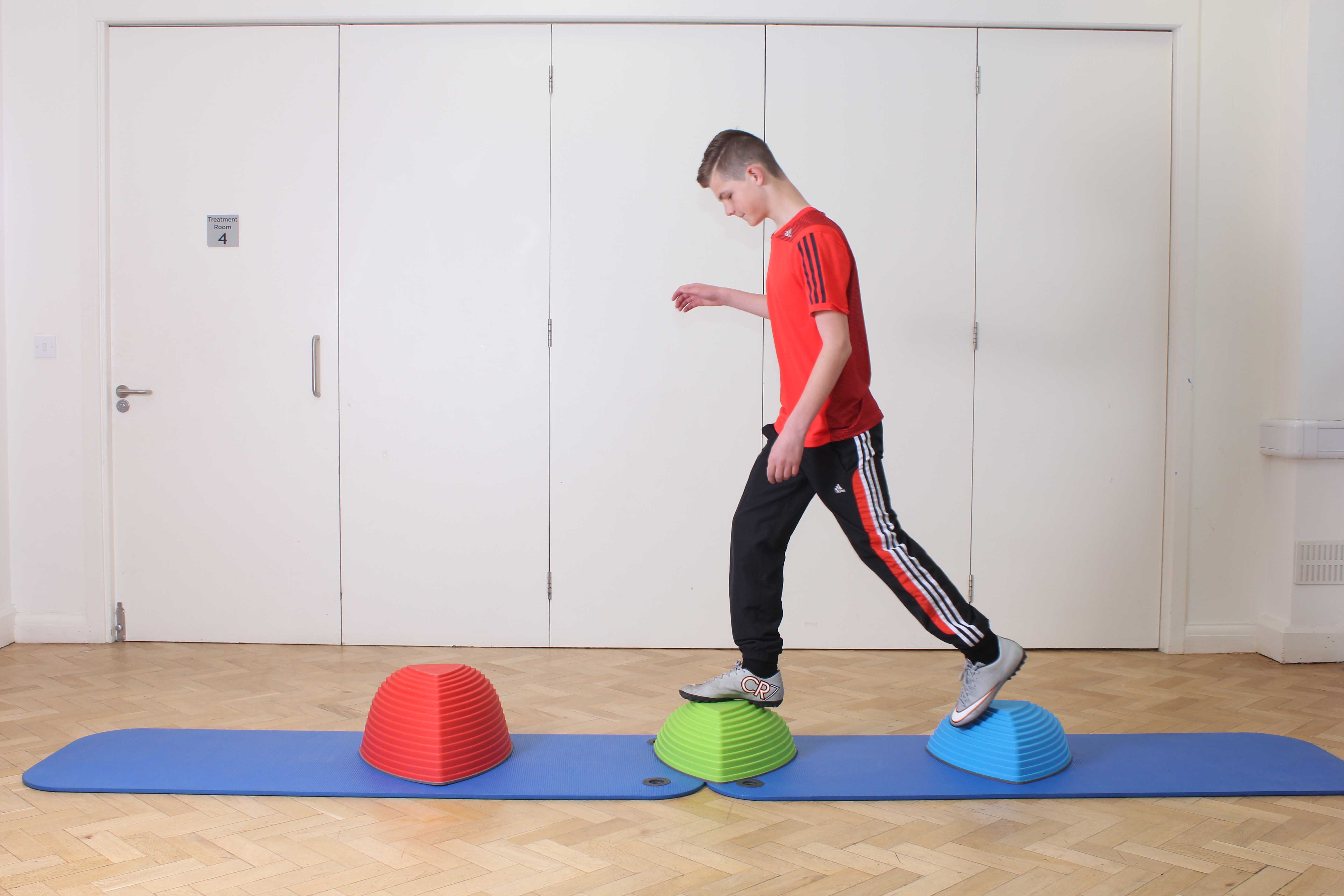 Ankle stability exercises, with supportive tape, supervised by therapist