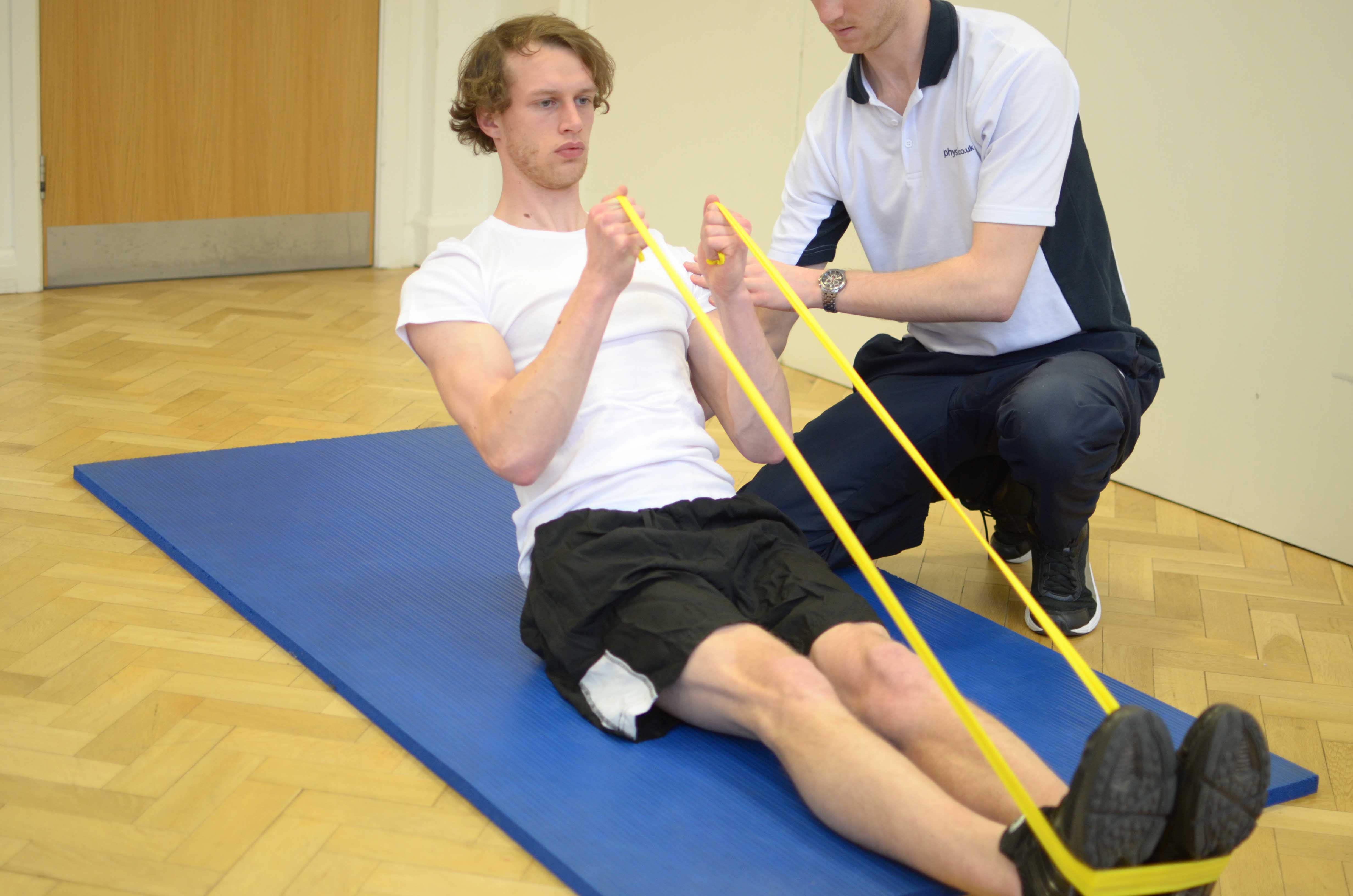 Core Strengthening exercises facilitated with a resistance band and supervised by a physiotherapist