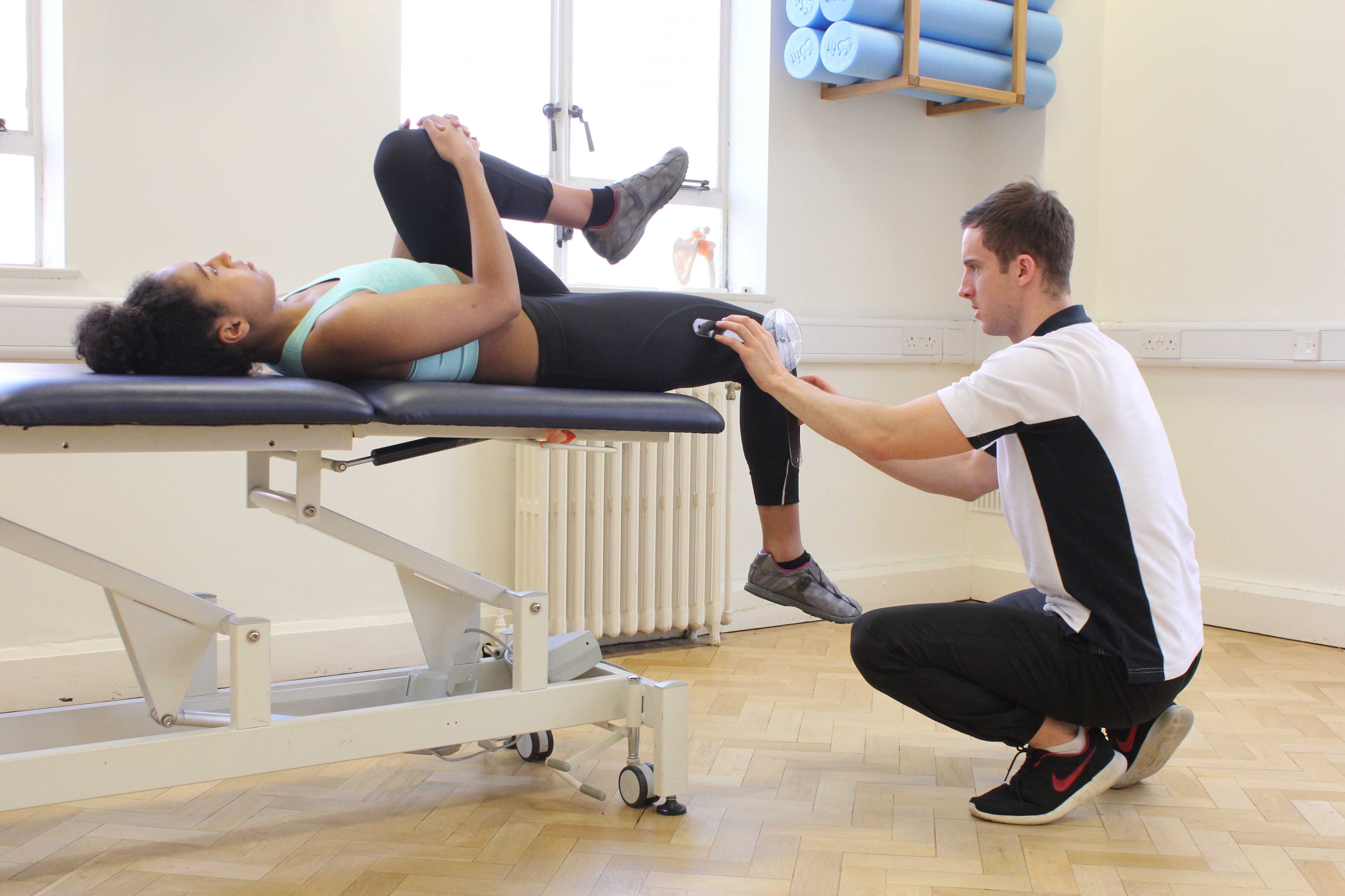 Passive stretch of the muscles and connective tissues of the hip and pelvis by specialist therapist