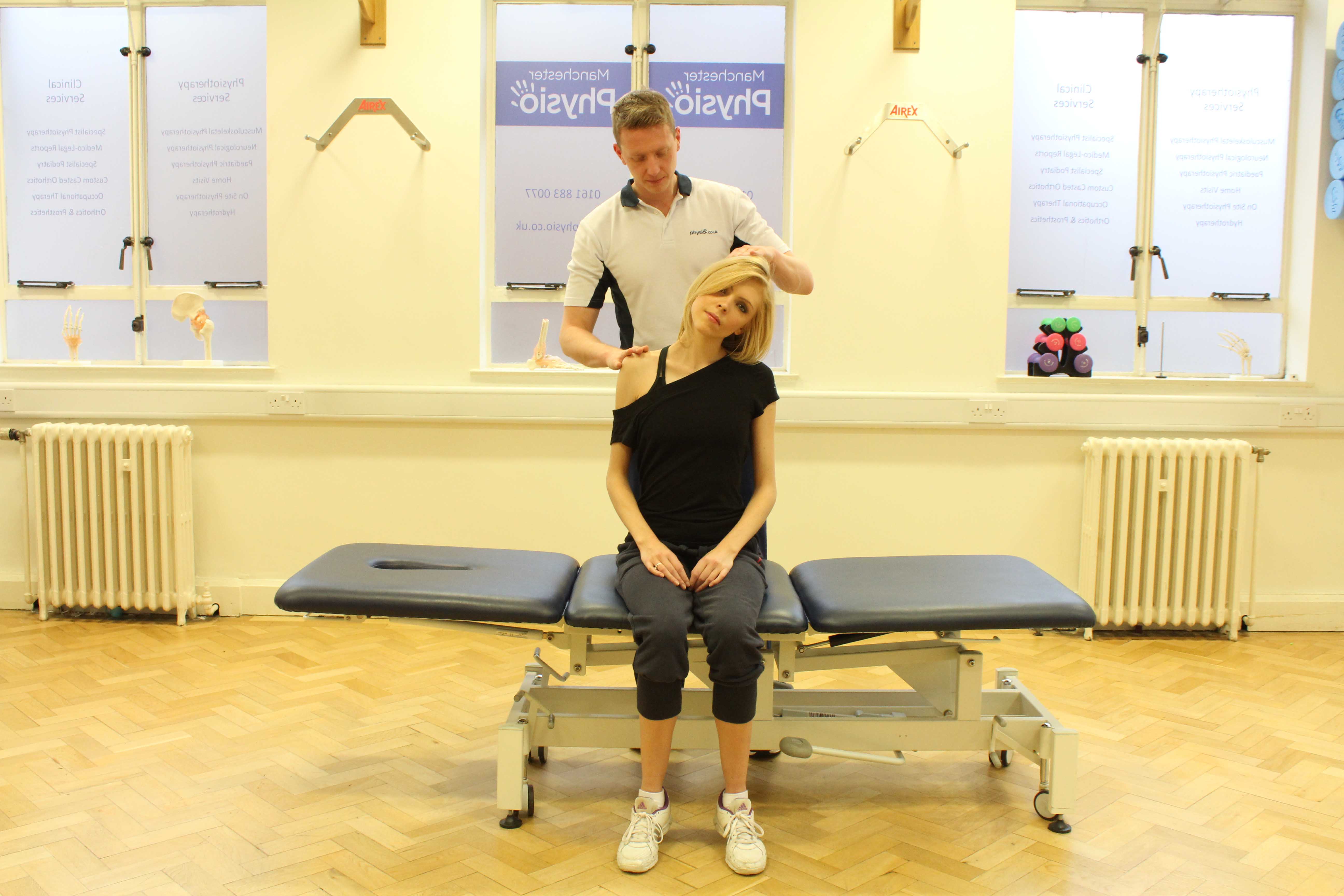 Experienced Physiotherapist conducting an assessment of the cervical spine, muscles and connective tissues in the neck