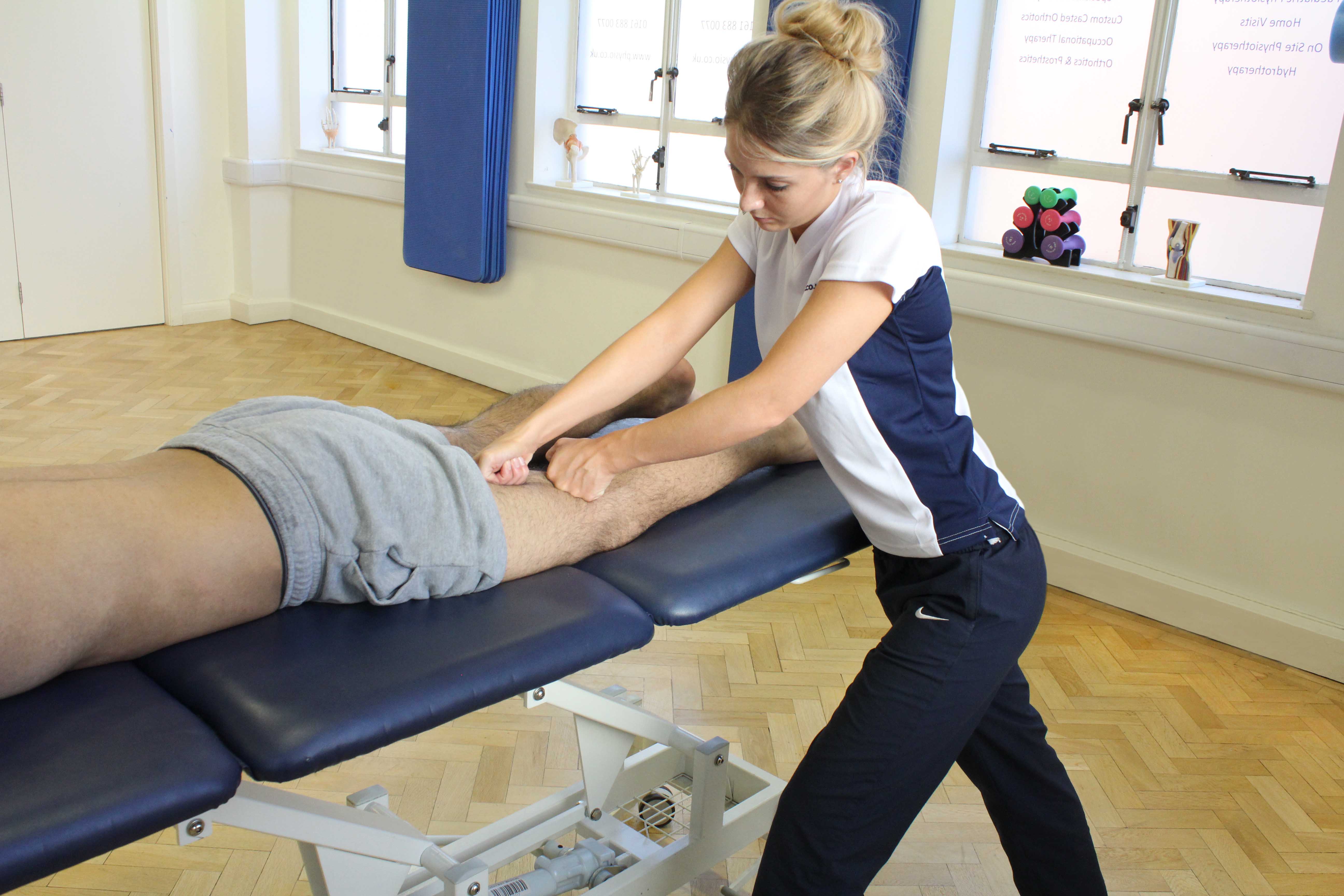 Kneading soft tissue massage of the hamstring muscles by an experienced therapist 