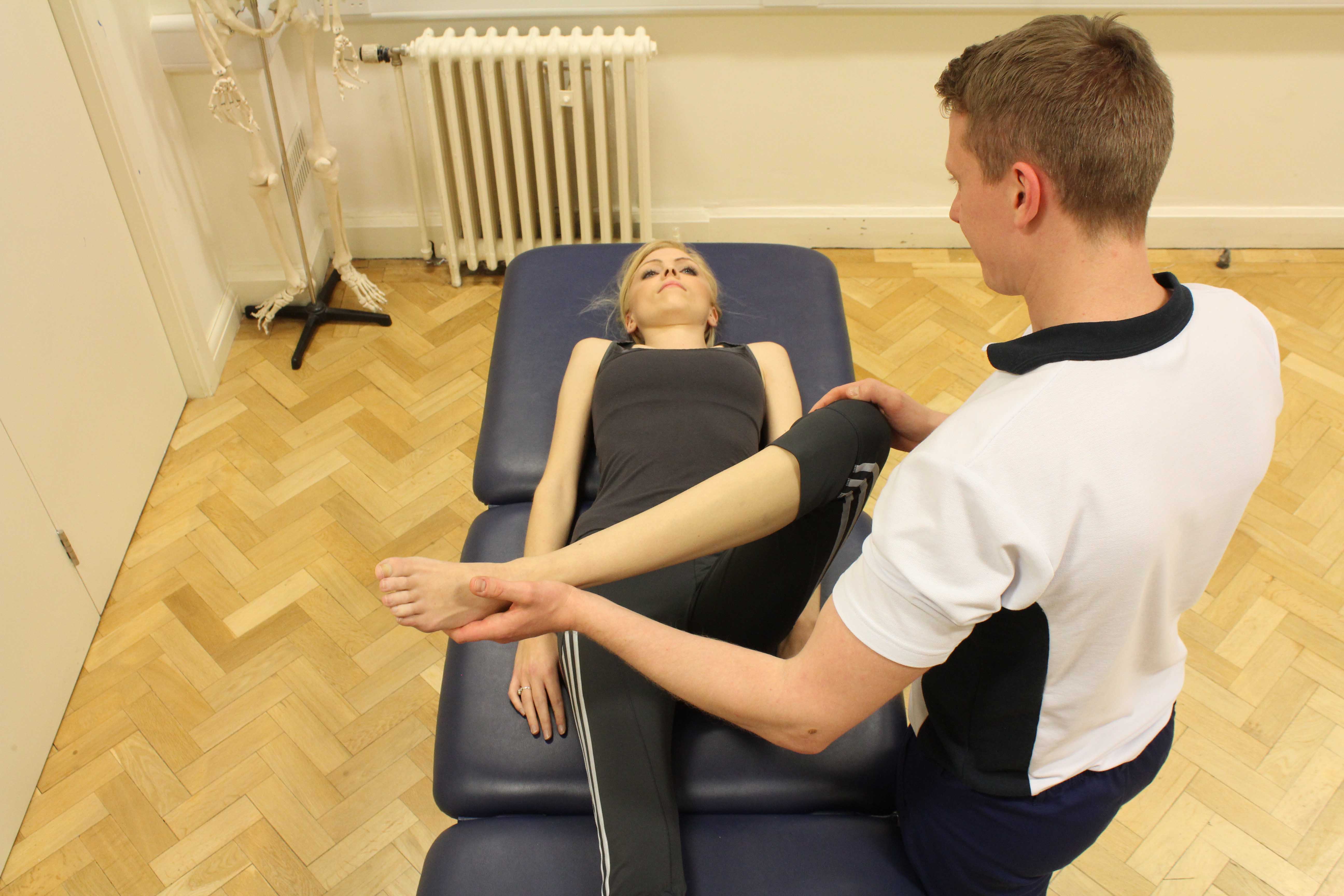 Therapist performing knee assessment