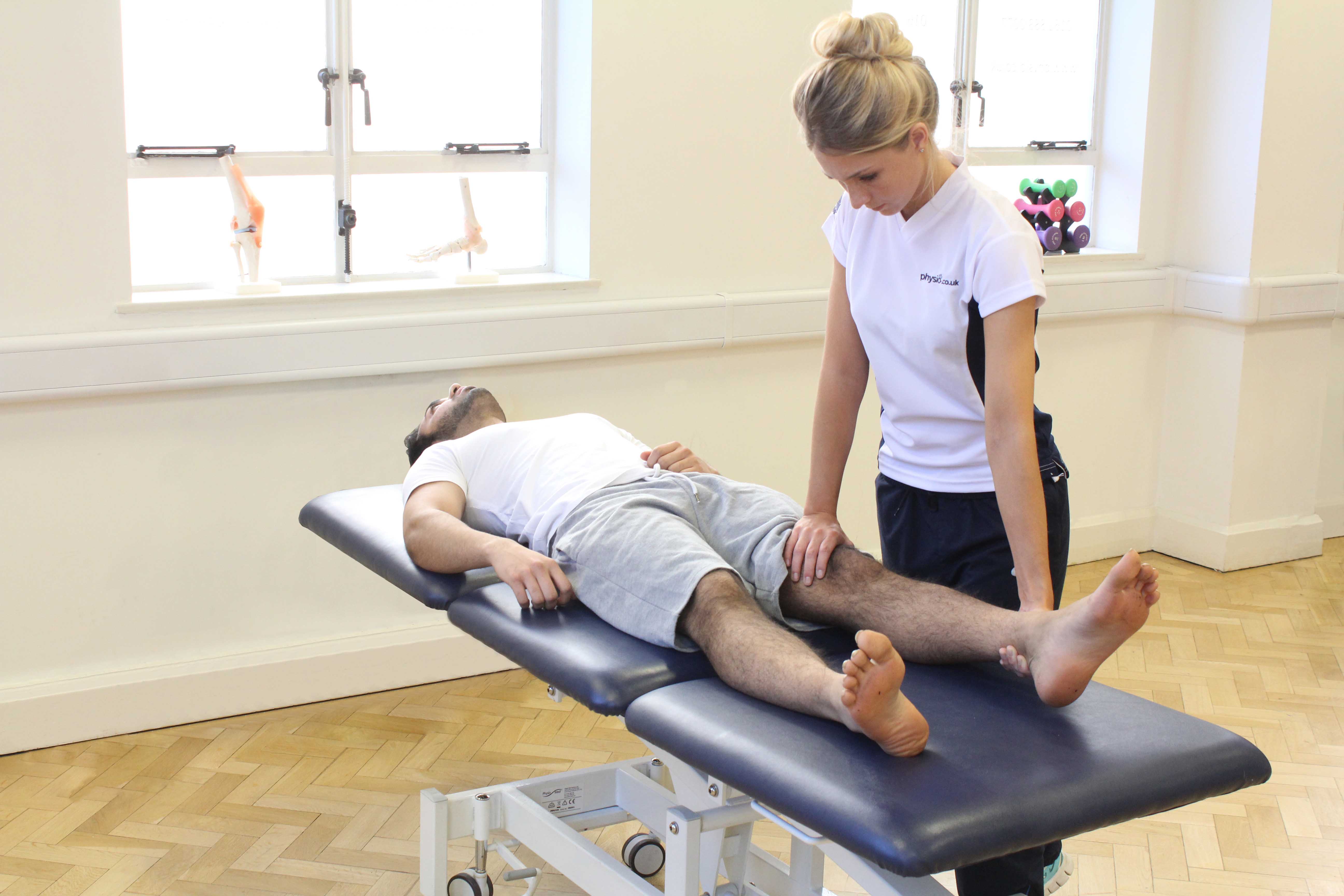 Therapist performing knee assessment