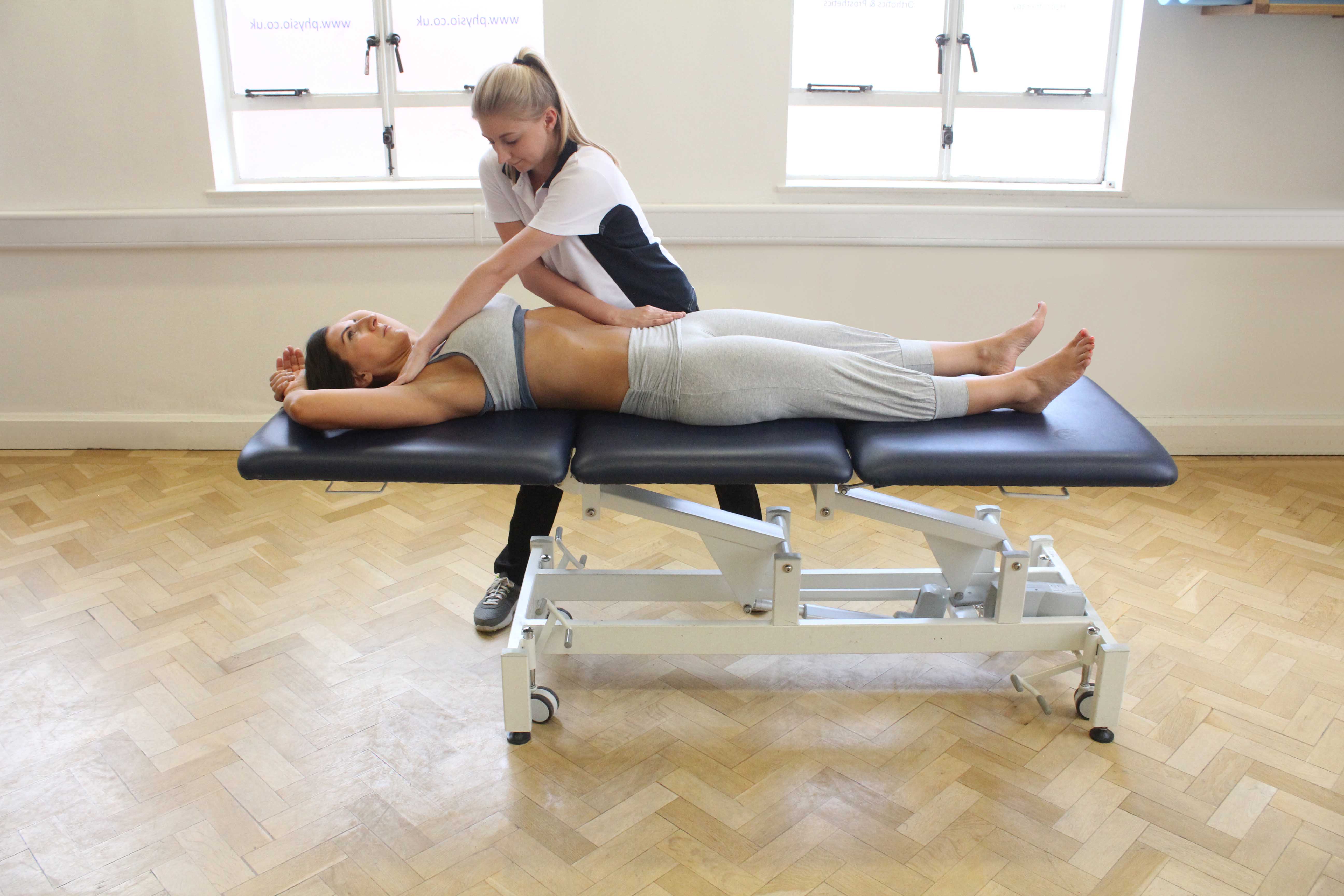 Passive stretch of the muscles and connective tissues of the hip and pelvis by specialist therapist