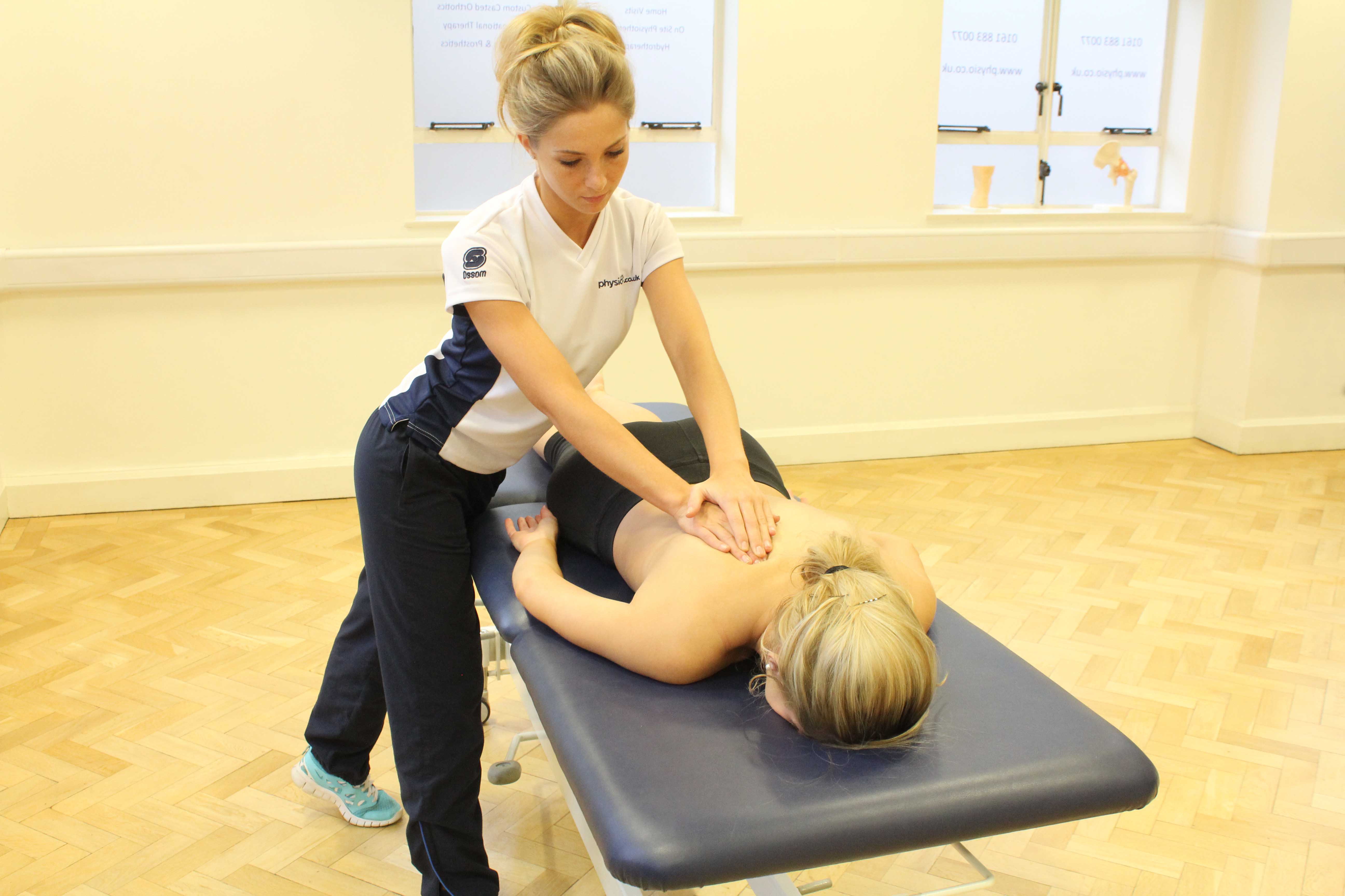 Soft tissue massage of the upper back muscles