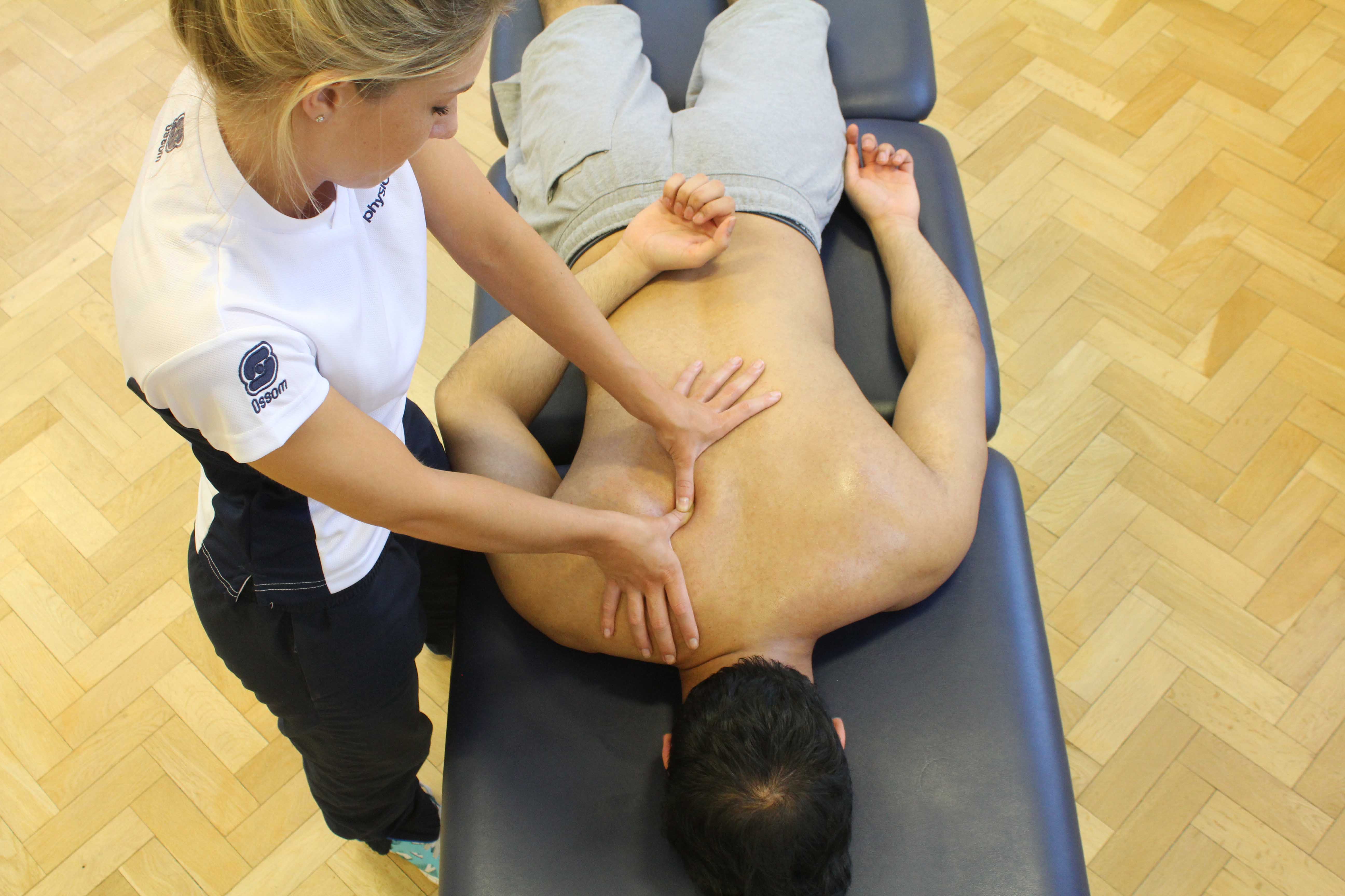 Trigger point massage of the muscles in the upper back Trigger point massage of the muscles in the upper back
