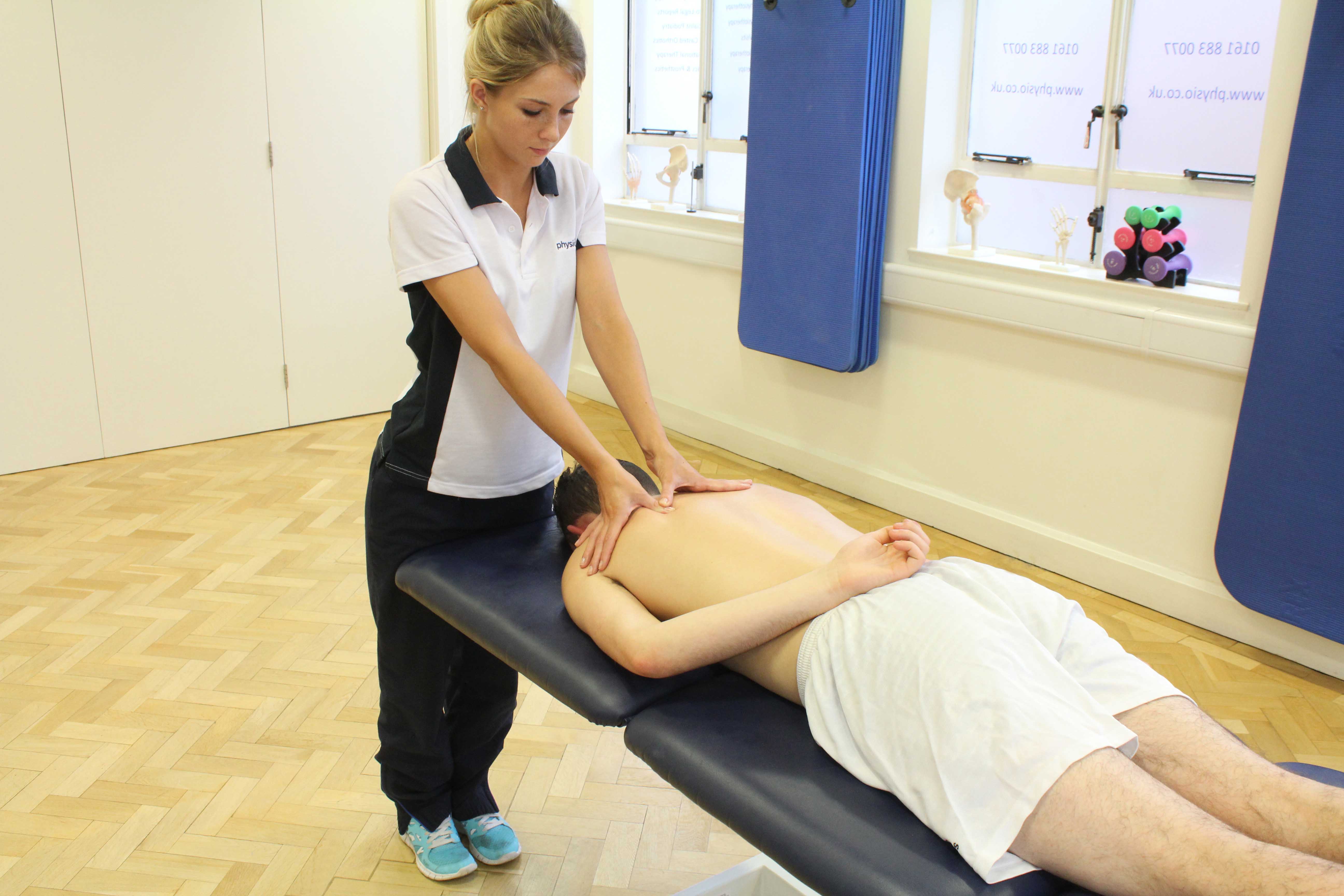 Trigger point massage of upper back muscle Trigger point massage of upper back muscle