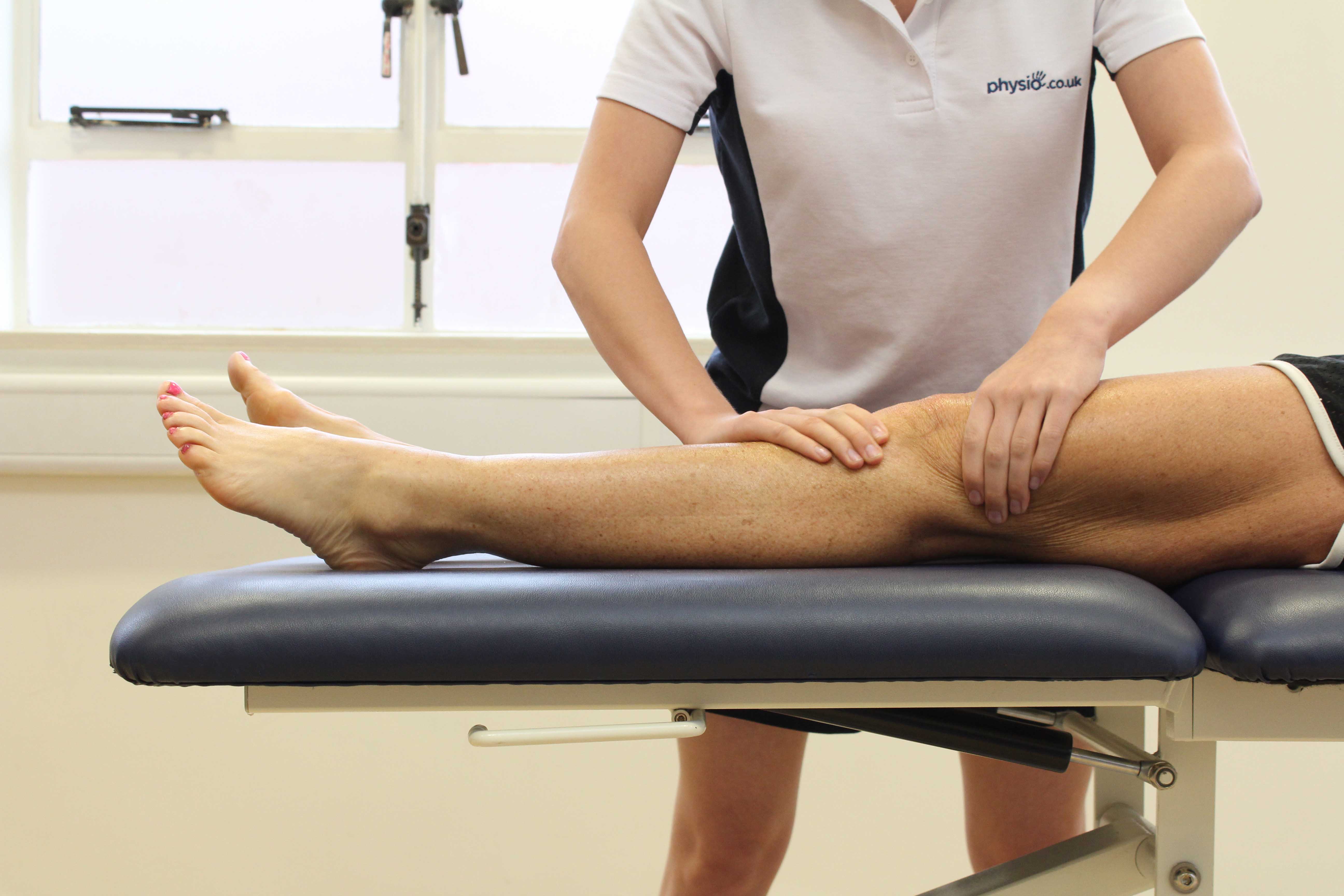 Soft tissue massage of the muscle and connective tissues around the knee