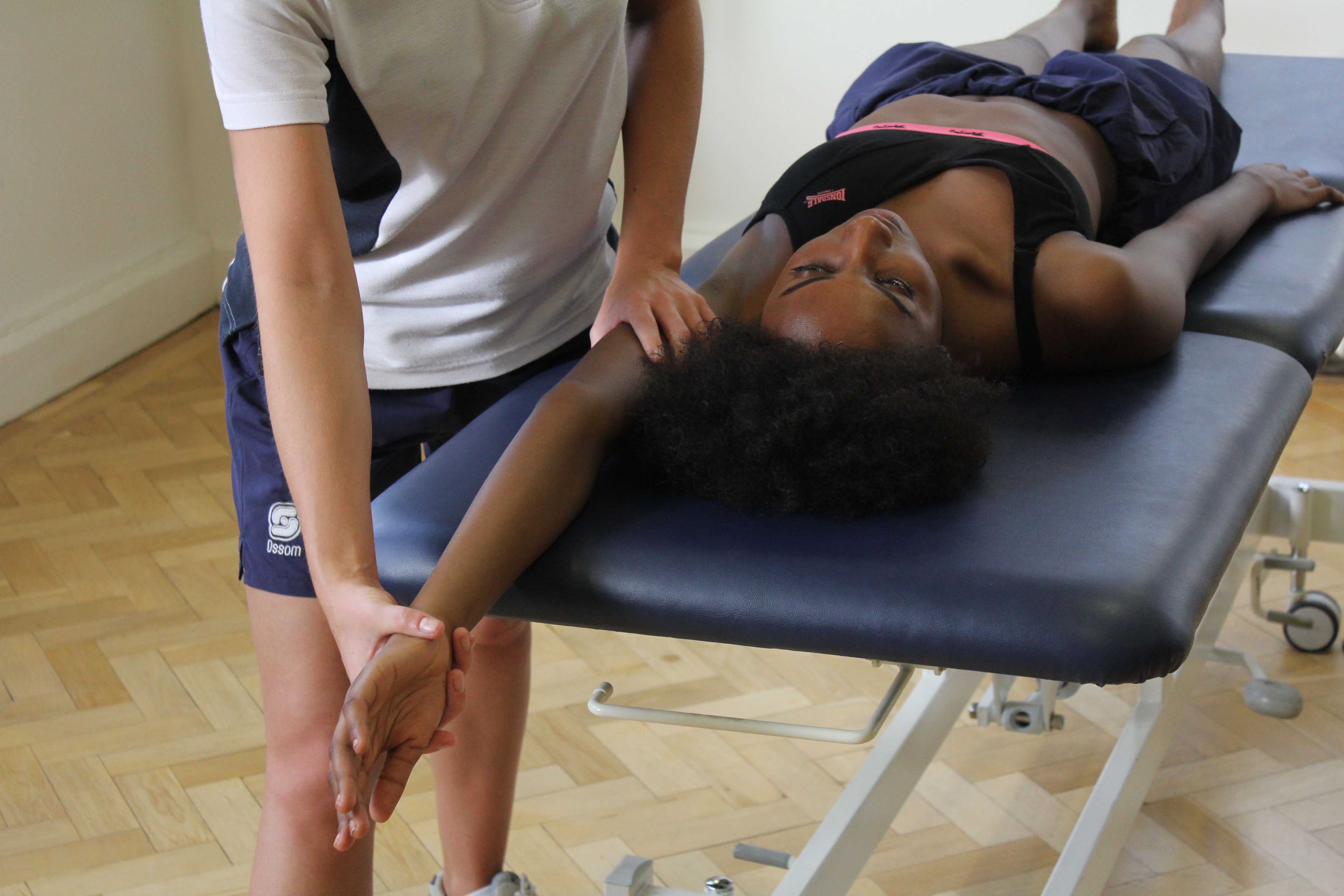 Massage and stretch of glenohumeral joint to ease tight muscles