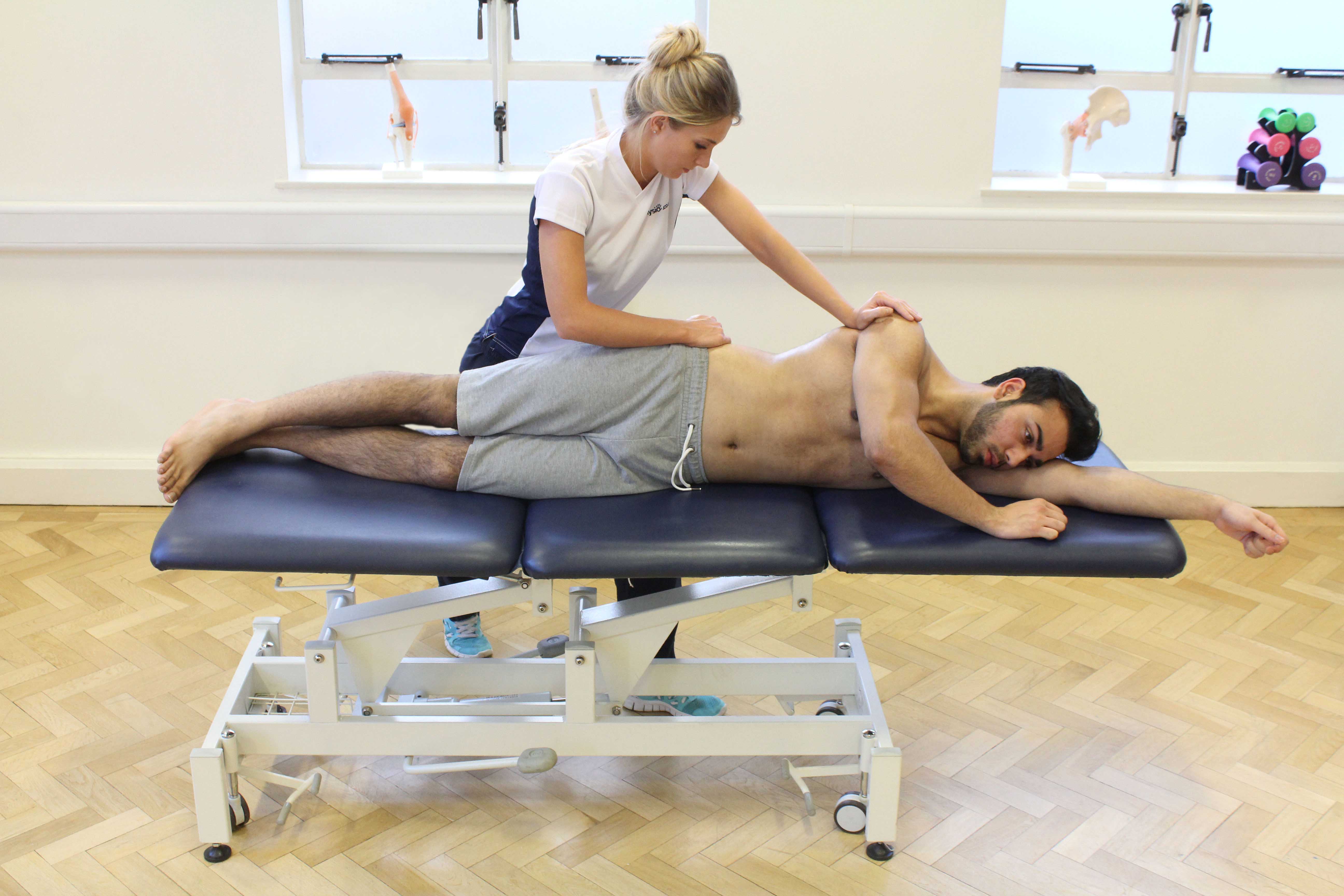 Therapist applying traction to stretch soft tissues and provide relief from pain and stiffness Therapist applying traction to stretch soft tissues and provide relief from pain and stiffness