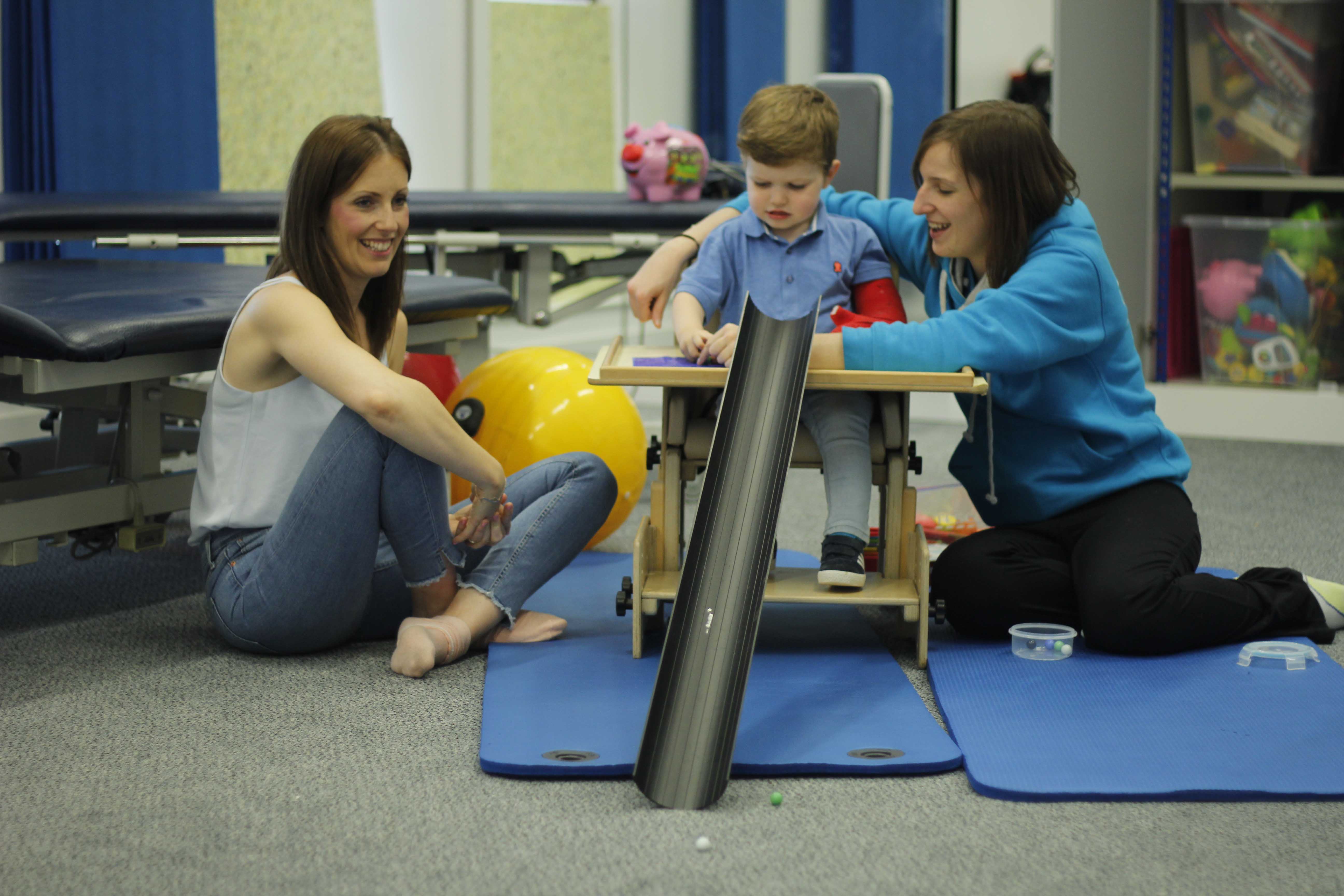 Practicing fuctional transfers to a bed with close supervision from a neurological physiotherapist