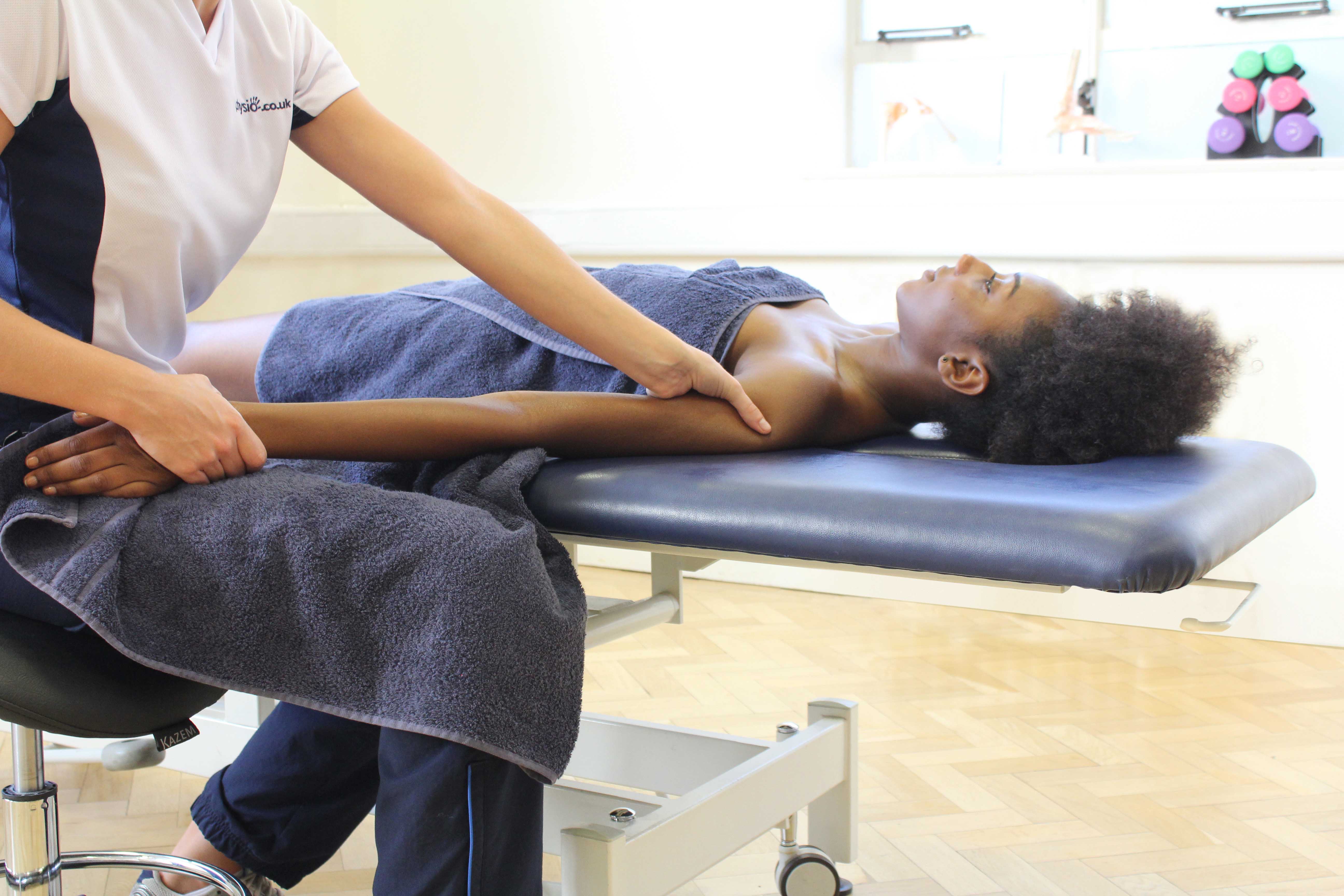 Soft tissue massage of the biceps and deltoids of the upper arm Soft tissue massage of the biceps and deltoids of the upper arm