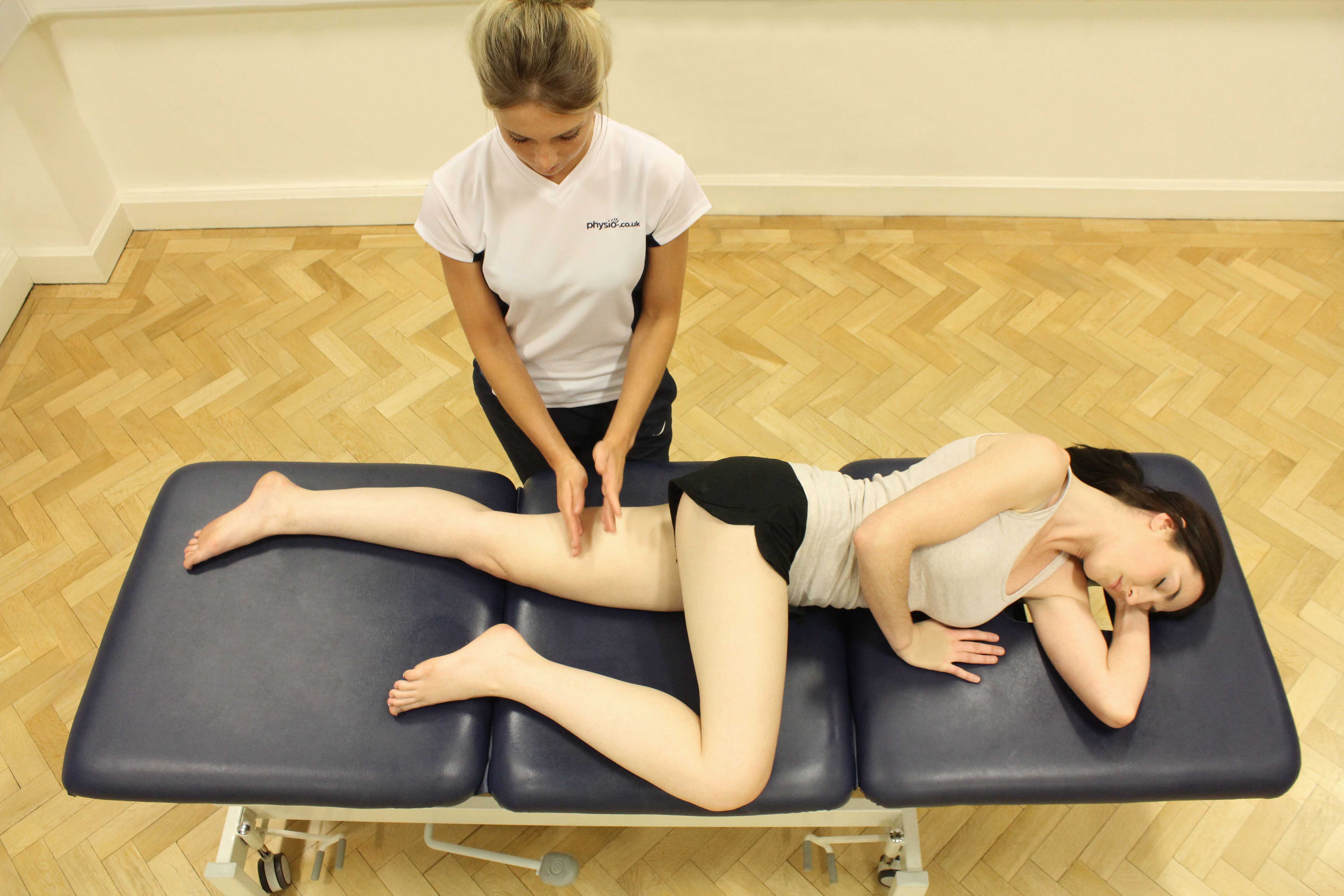 Hacking percussion soft tissue massage of the hamstring muscles by specialist MSK therapist