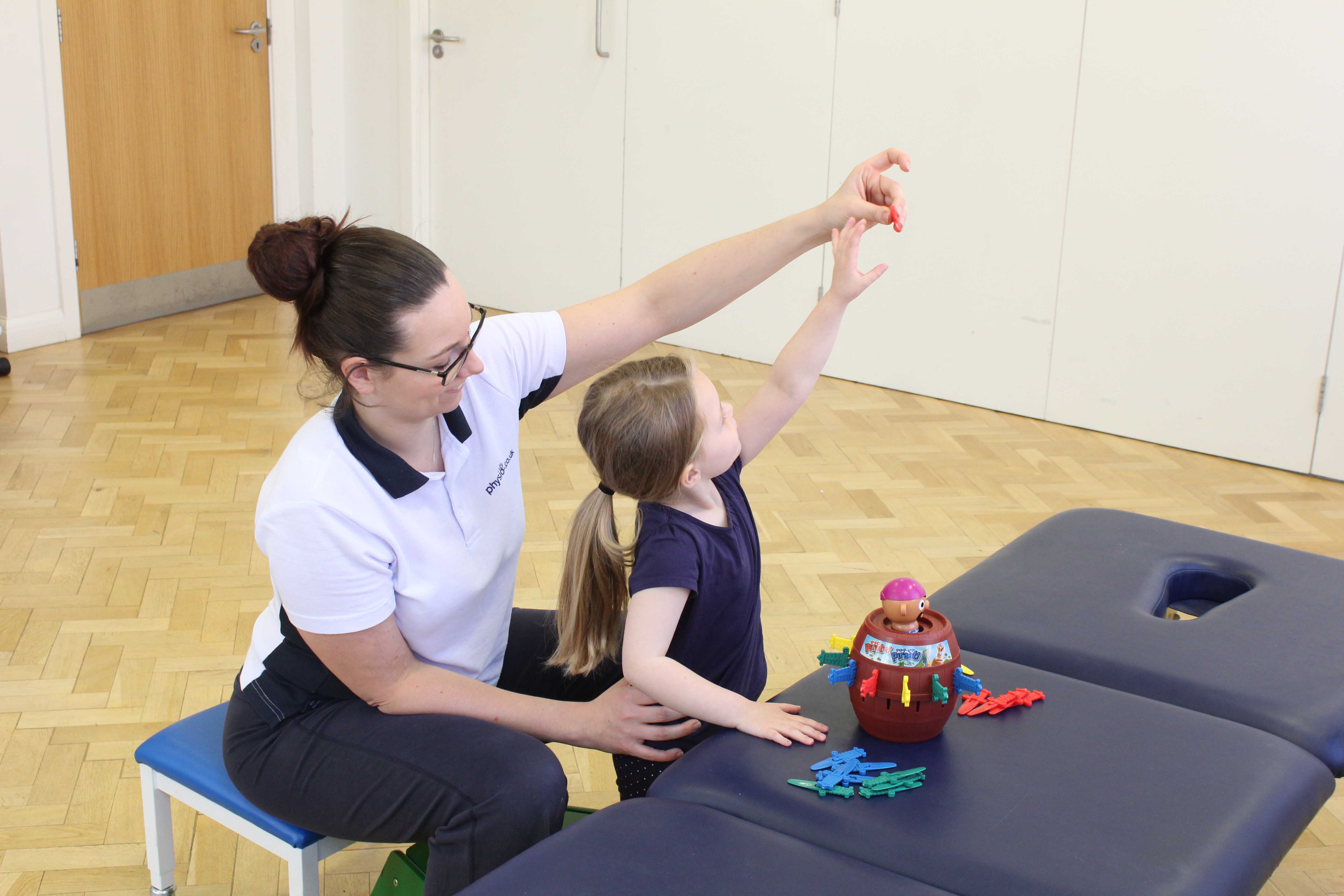 Developing fine motor skills through play activities supervised bya paediatric physiotherapist Developing fine motor skills through play activities supervised bya paediatric physiotherapist