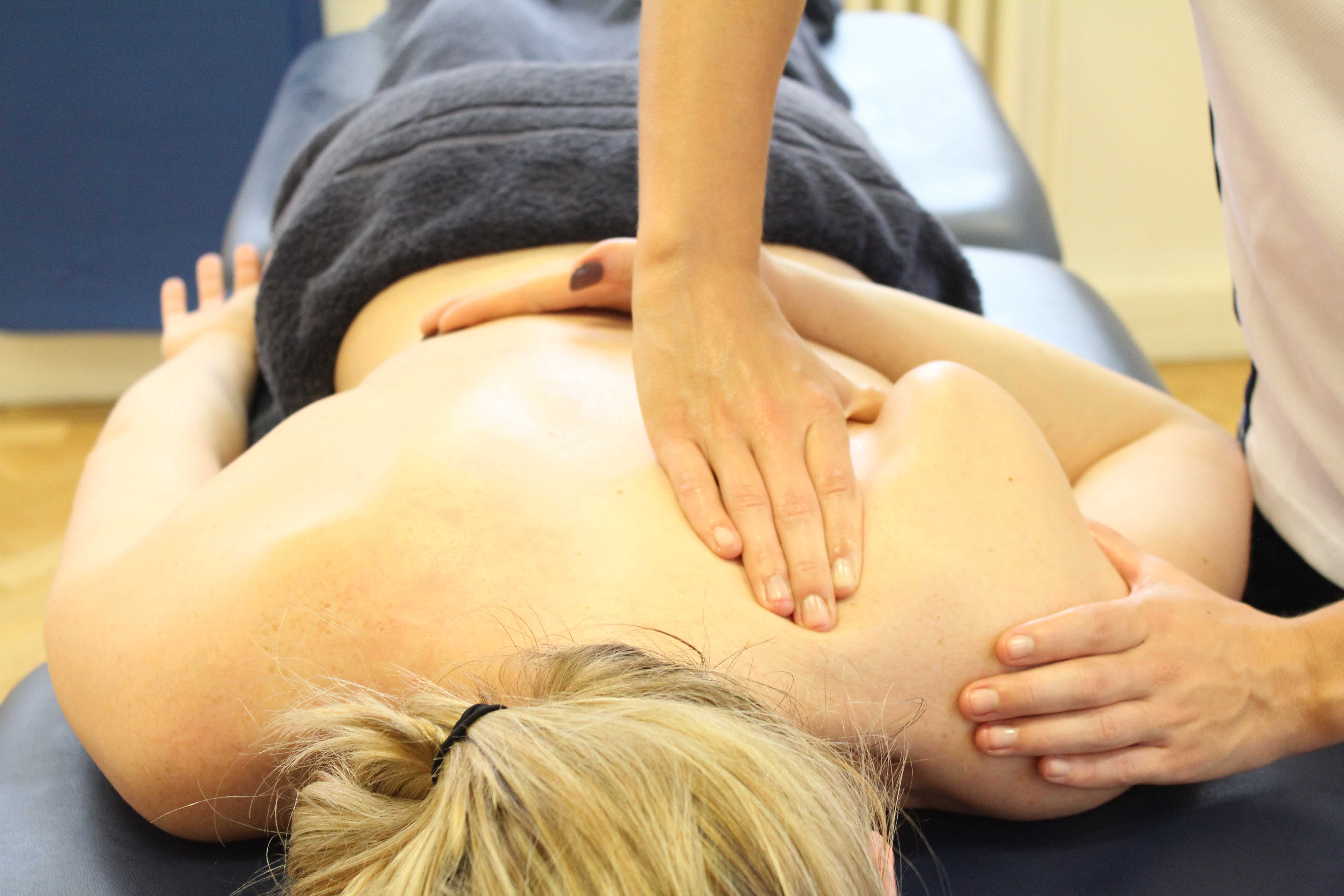 Therapist massage and realignment around a winging scapula Therapist massage and realignment around a winging scapula