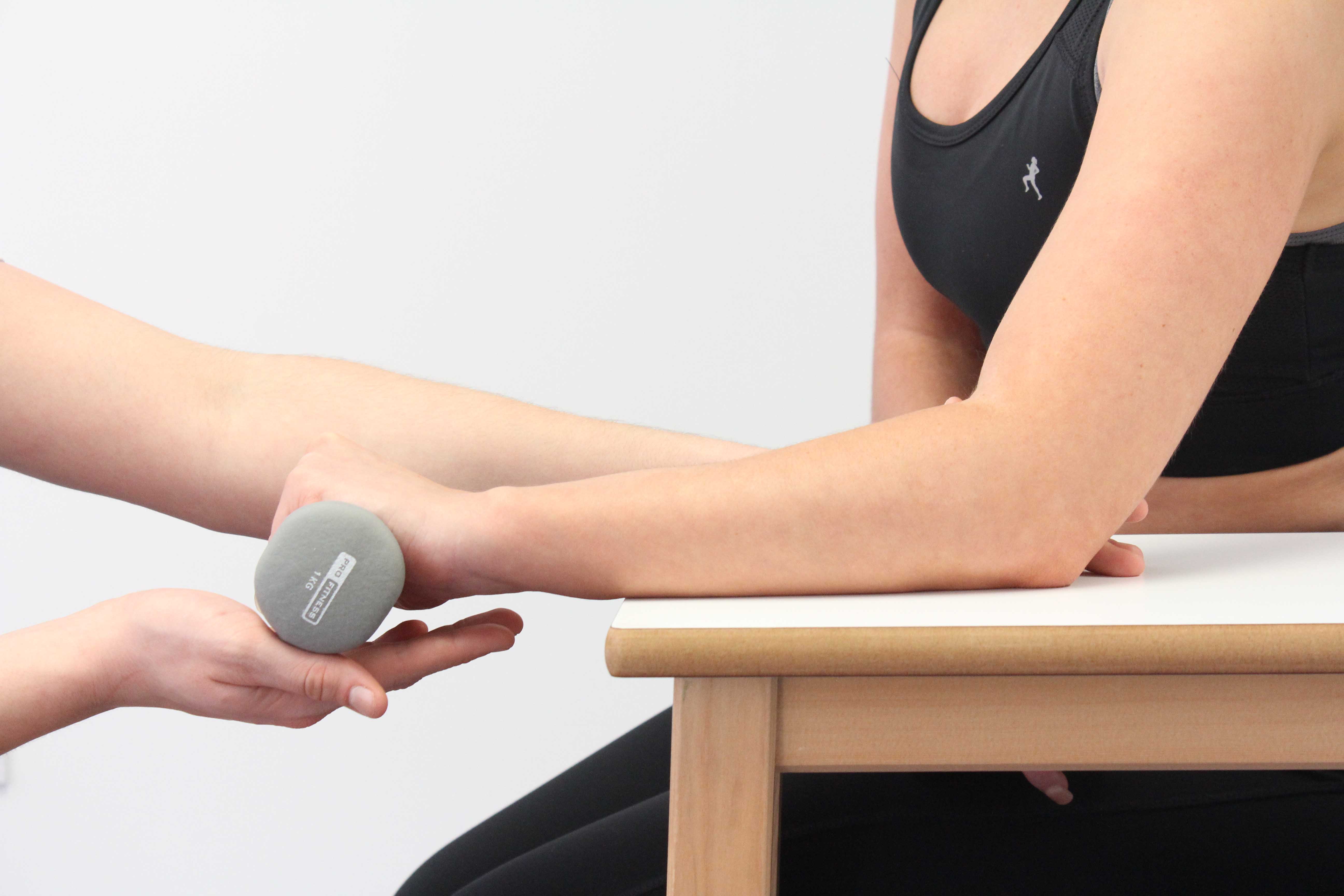 Progressive wrist strengthening exercises supervised by physiotherapist